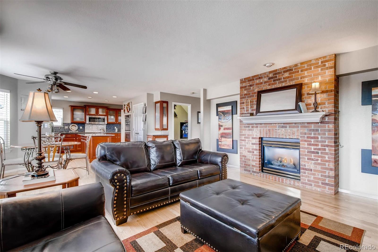 1665 Spring Water Lane Highlands Ranch, CO 80129 - Photo 16 of 34 a living room with furniture and a fireplace