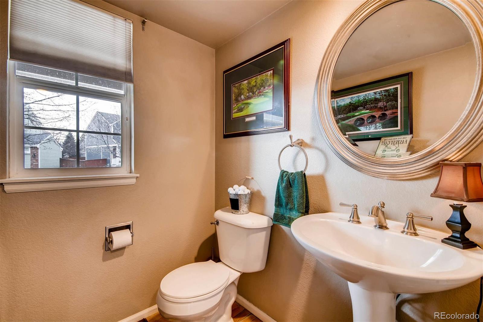 1665 Spring Water Lane Highlands Ranch, CO 80129 - Photo 18 of 34 a bathroom with a toilet a sink and a mirror