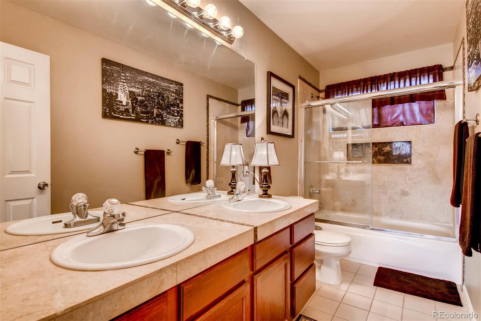 1665 Spring Water Lane Highlands Ranch, CO 80129 - Photo 26 of 34 a bathroom with a sink a toilet and shower