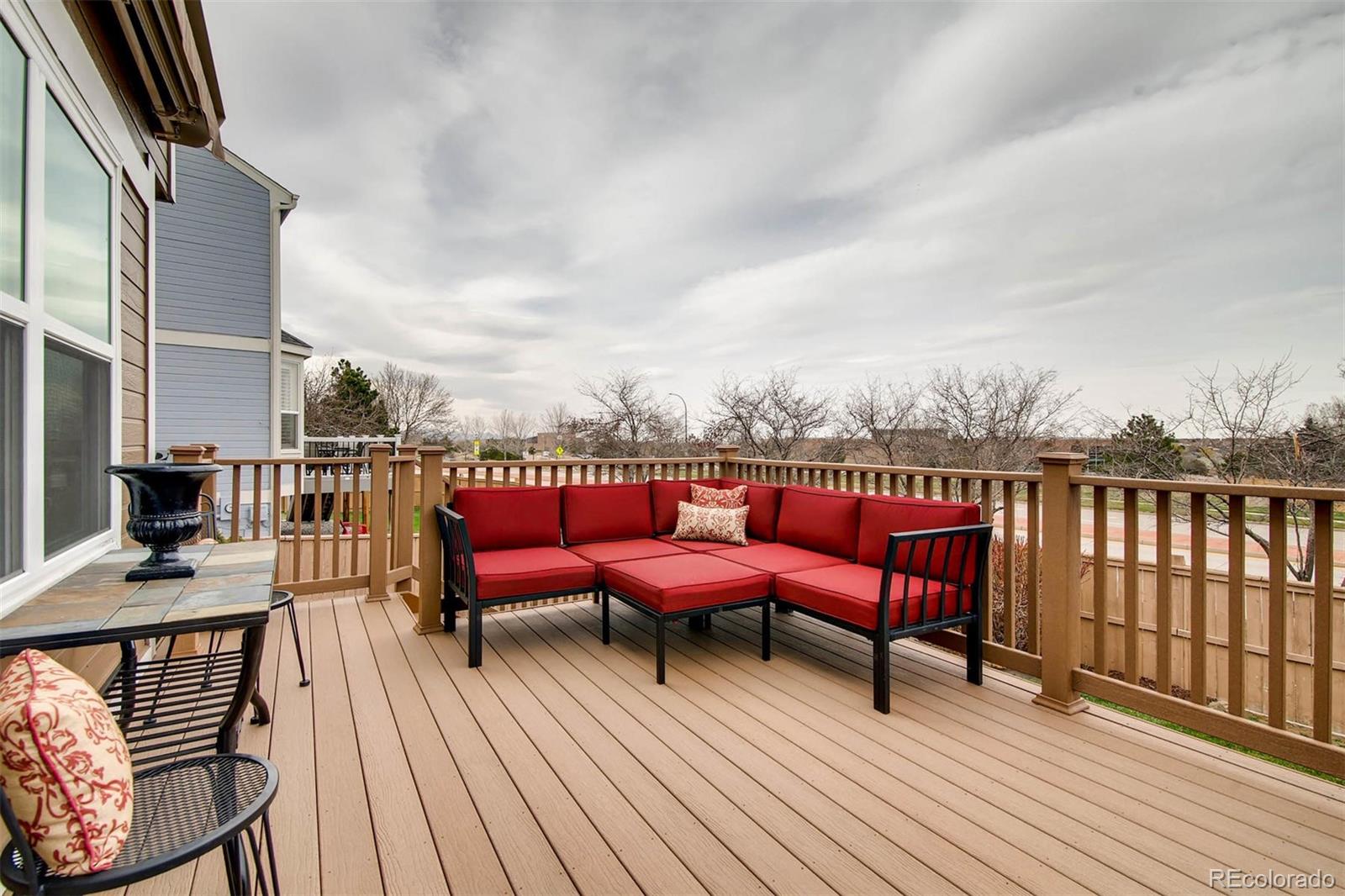 1665 Spring Water Lane Highlands Ranch, CO 80129 - Photo 31 of 34 a balcony with wooden floor table and chairs