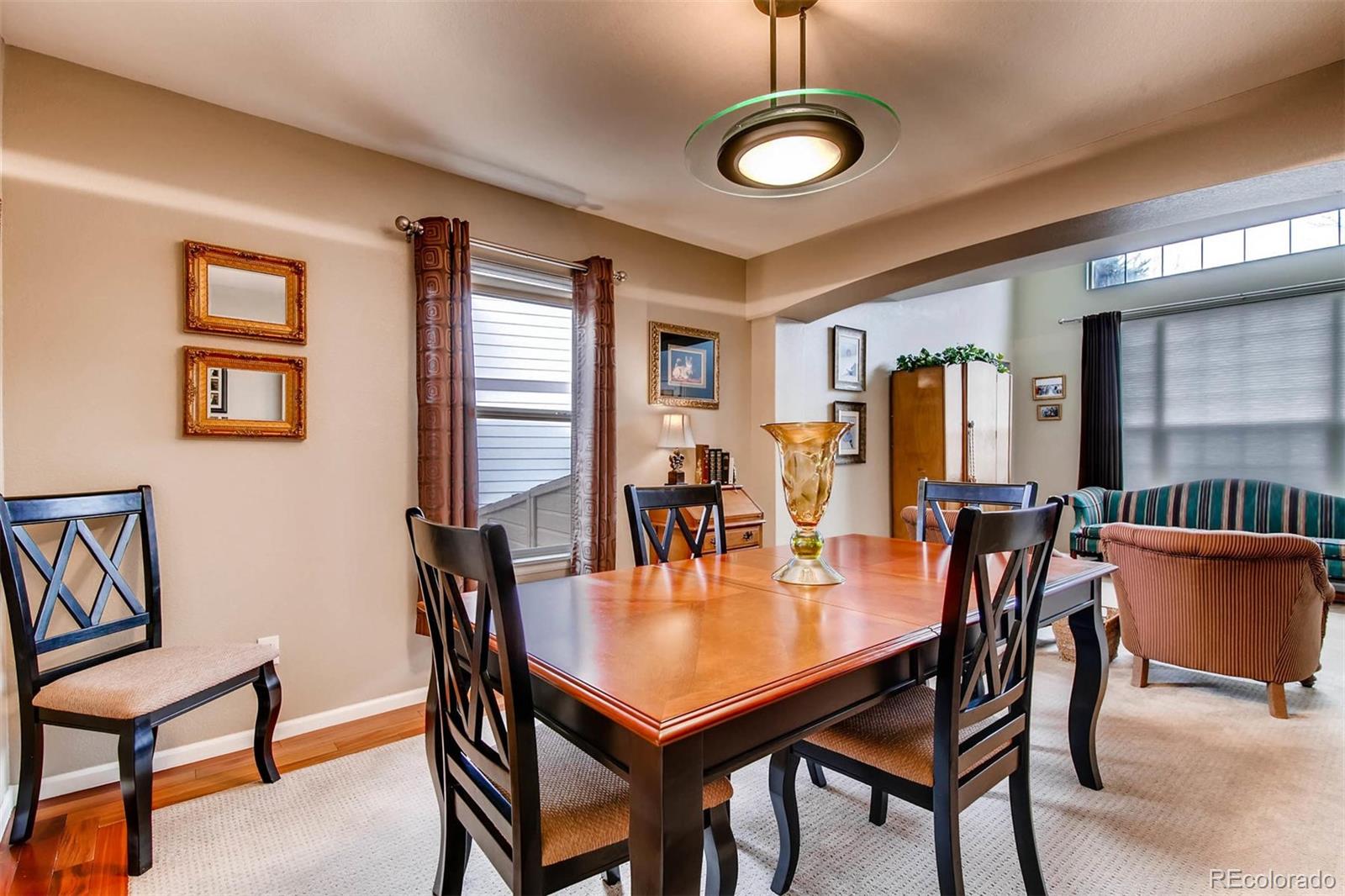 1665 Spring Water Lane Highlands Ranch, CO 80129 - Photo 8 of 34 a dining room with furniture and window