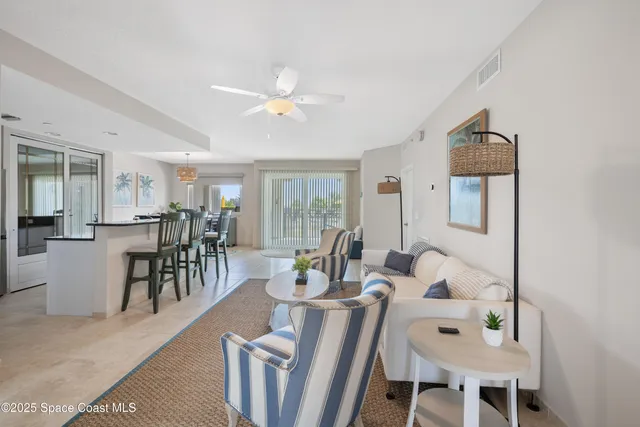 a living room with furniture a table and chairs