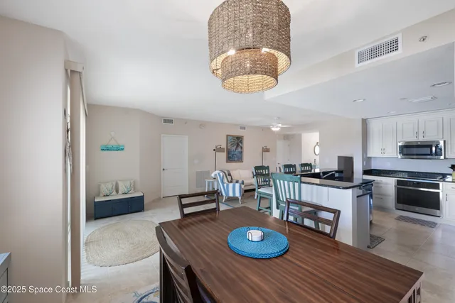 a kitchen with kitchen island granite countertop a refrigerator and a stove top oven