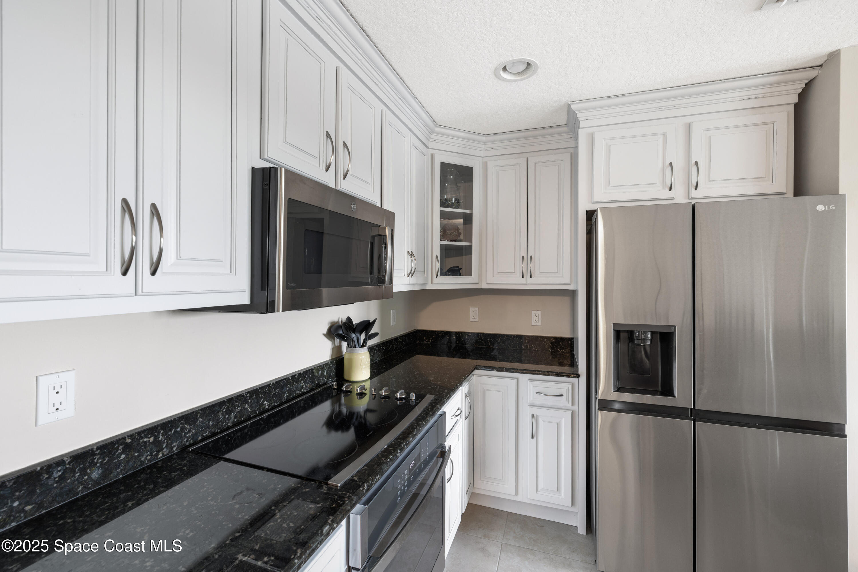1623 Indian River Drive, Unit 103 Sebastian, FL 32958 - Photo 22 of 36 a kitchen with granite countertop a refrigerator stove and sink