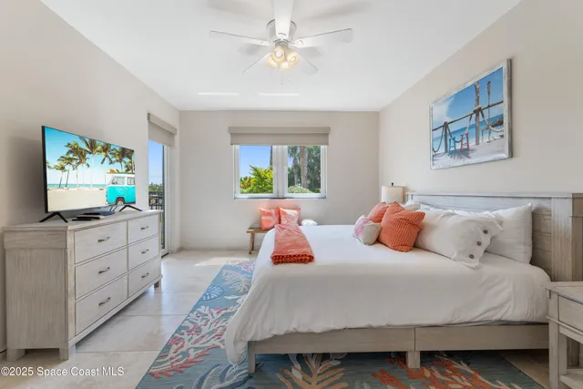 a bedroom with bed and a chandelier