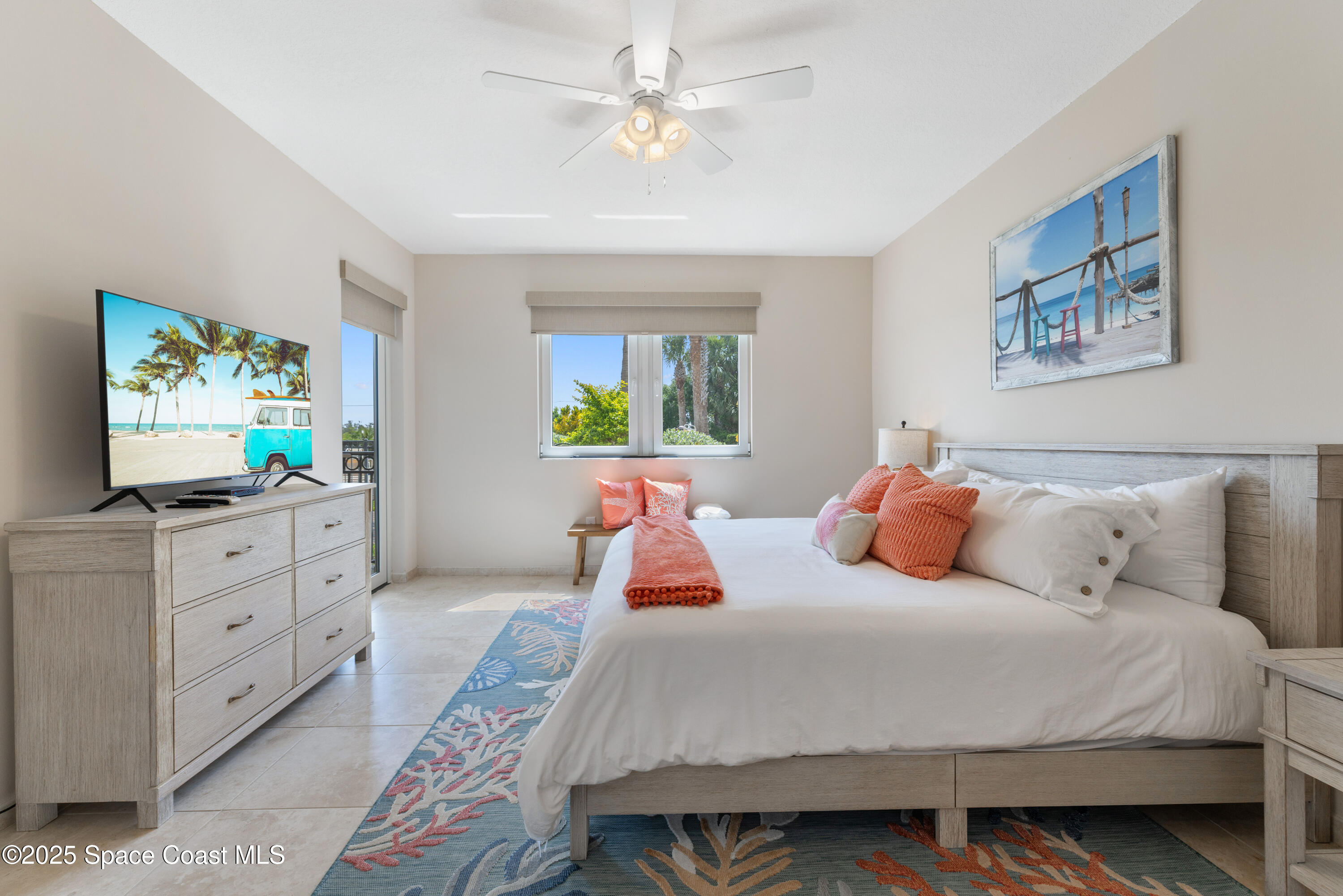 1623 Indian River Drive, Unit 103 Sebastian, FL 32958 - Photo 23 of 36 a bedroom with a large bed and a flat tv screen on dresser