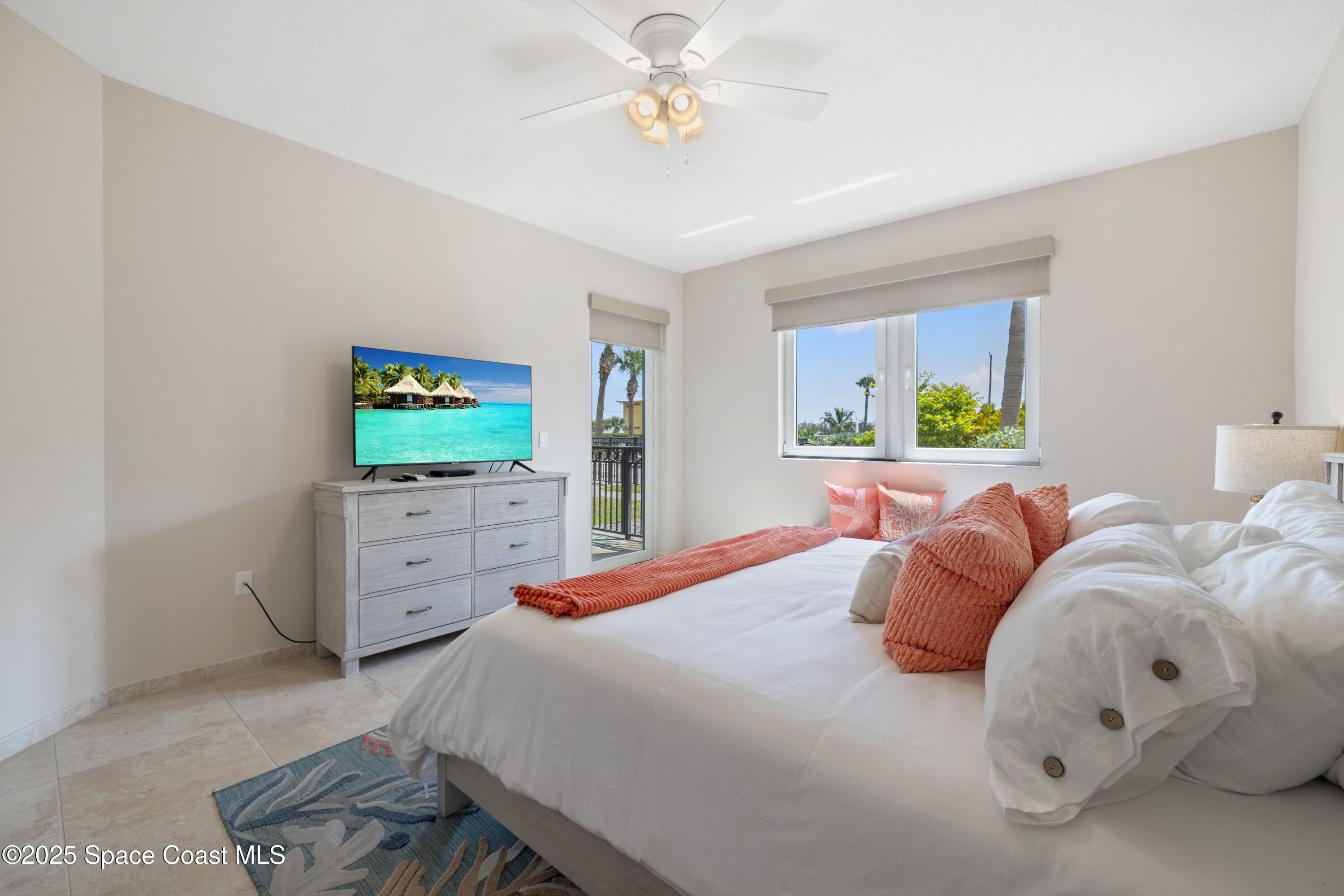 1623 Indian River Drive, Unit 103 Sebastian, FL 32958 - Photo 25 of 36 a bedroom with a bed and a flat screen tv