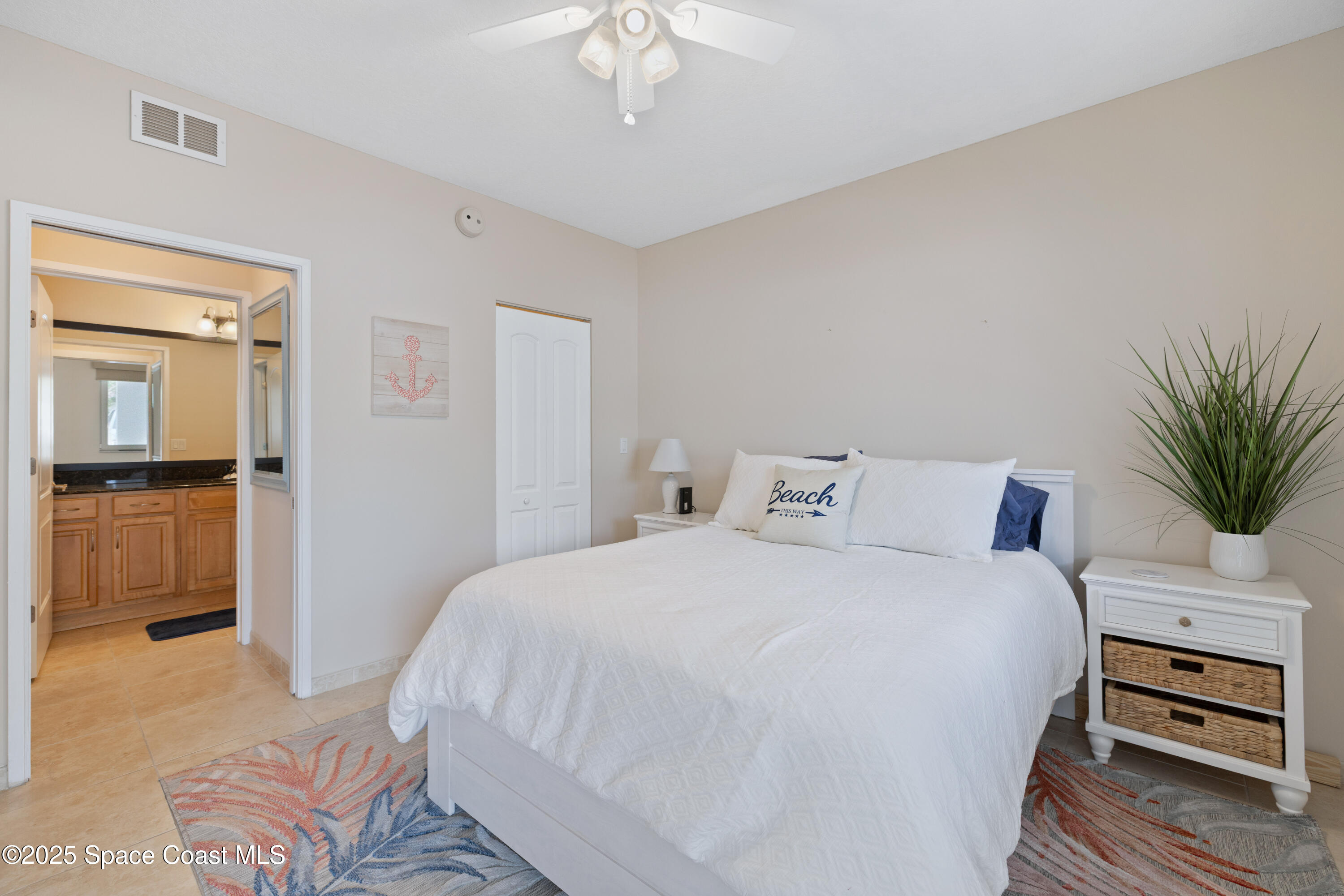 1623 Indian River Drive, Unit 103 Sebastian, FL 32958 - Photo 27 of 36 a bedroom with a bed and a view of kitchen