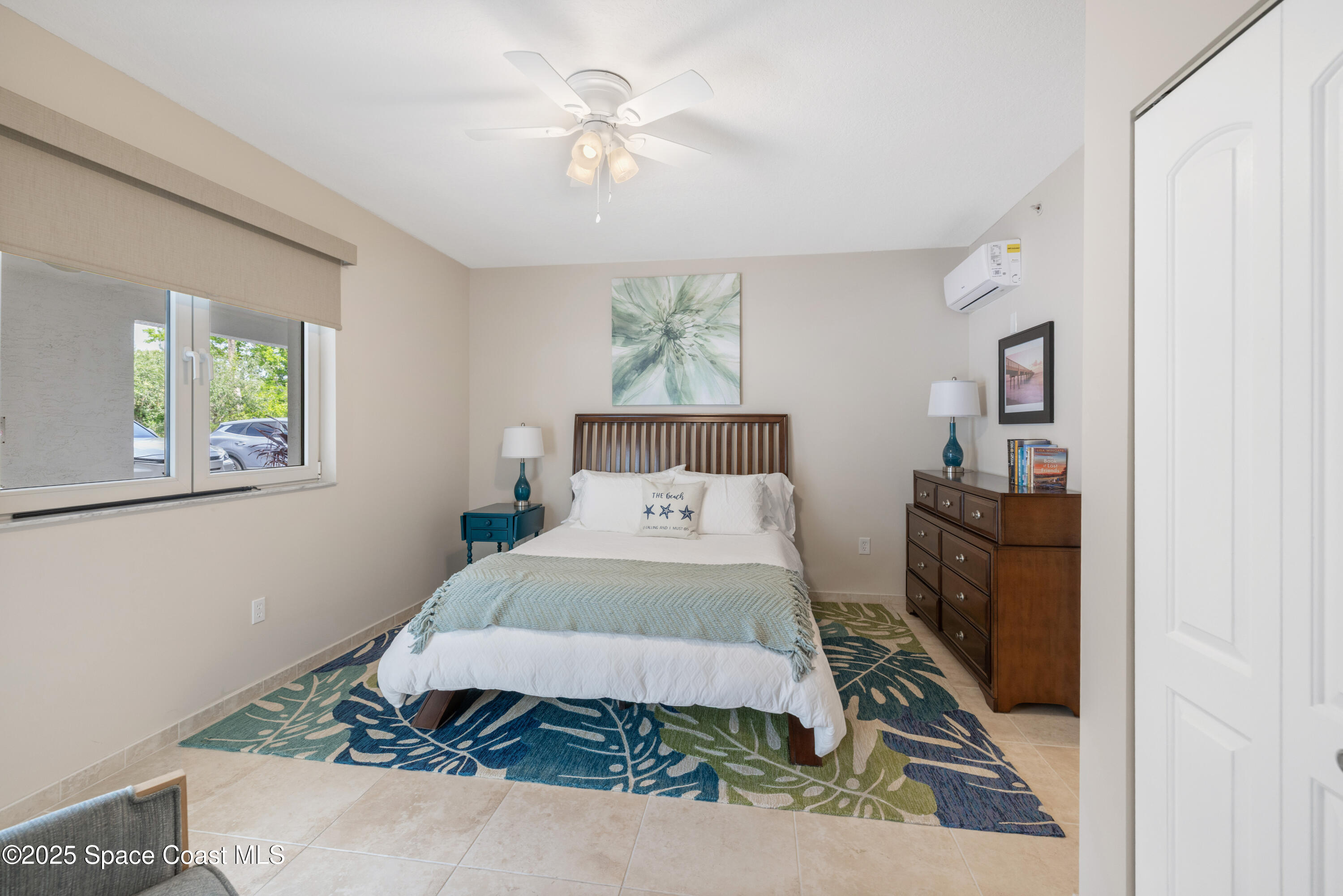 1623 Indian River Drive, Unit 103 Sebastian, FL 32958 - Photo 28 of 36 a bedroom with a bed and wooden floor