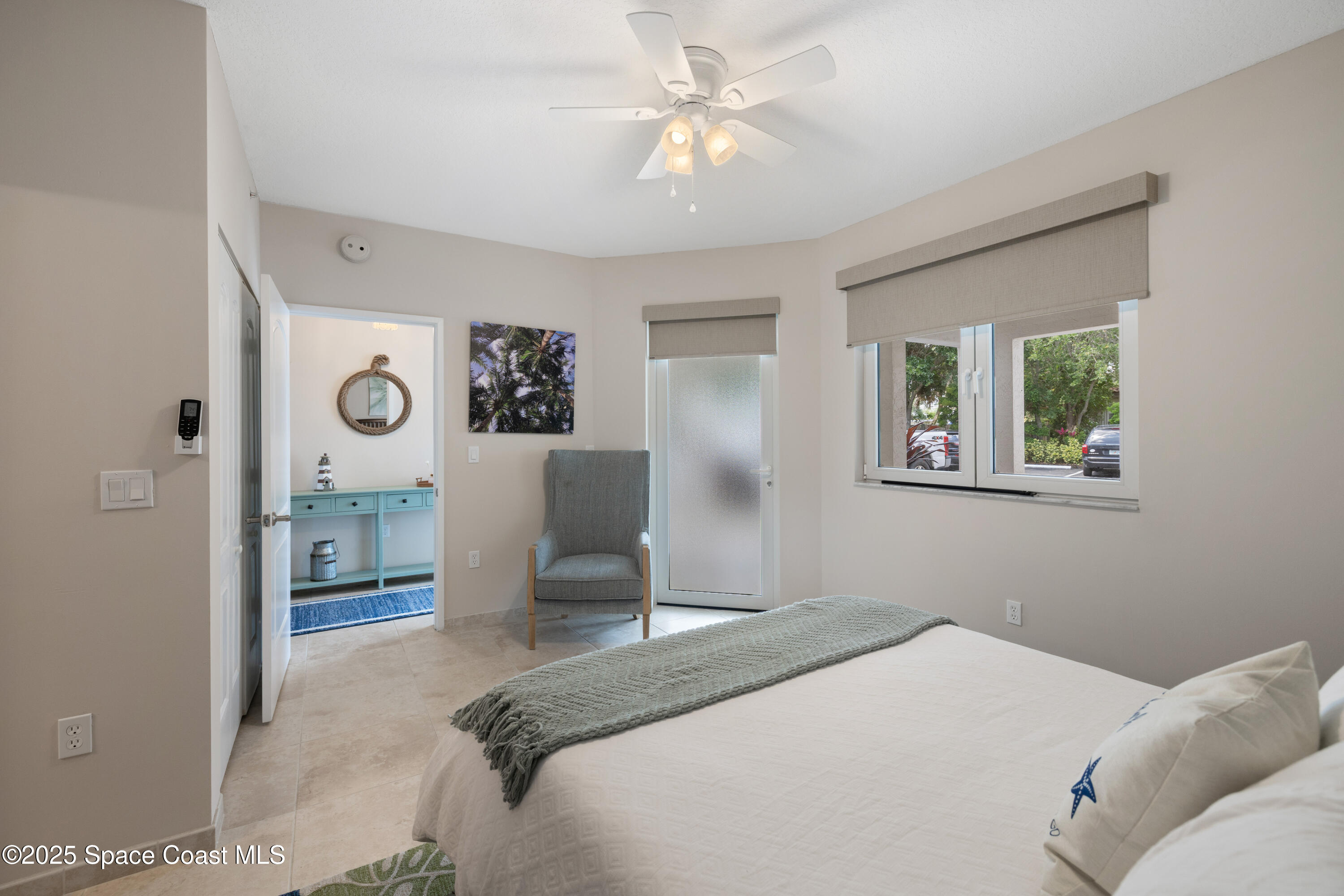 1623 Indian River Drive, Unit 103 Sebastian, FL 32958 - Photo 29 of 36 a bedroom with a bed and a chandelier