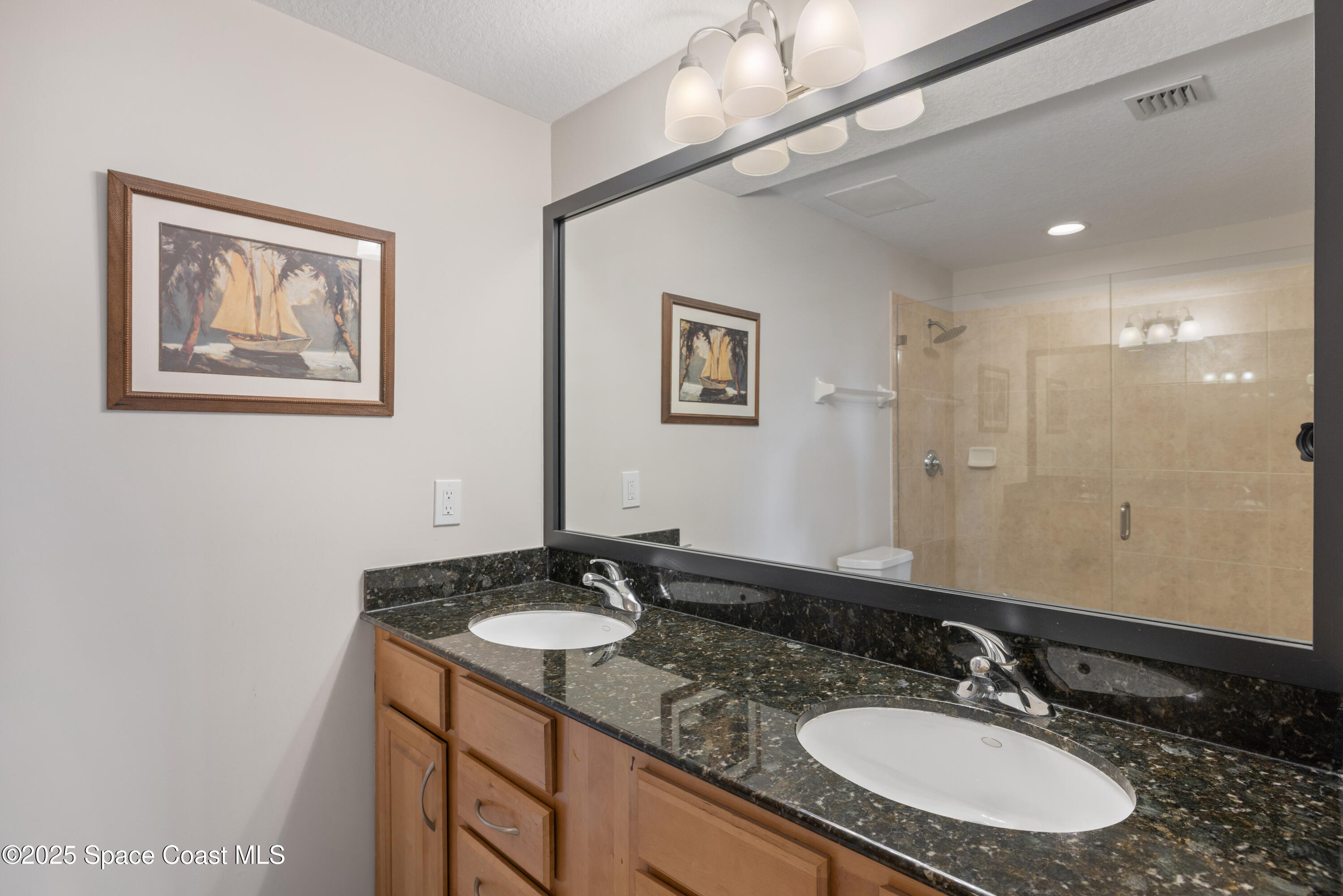 1623 Indian River Drive, Unit 103 Sebastian, FL 32958 - Photo 32 of 36 a bathroom with a sink double vanity and a mirror