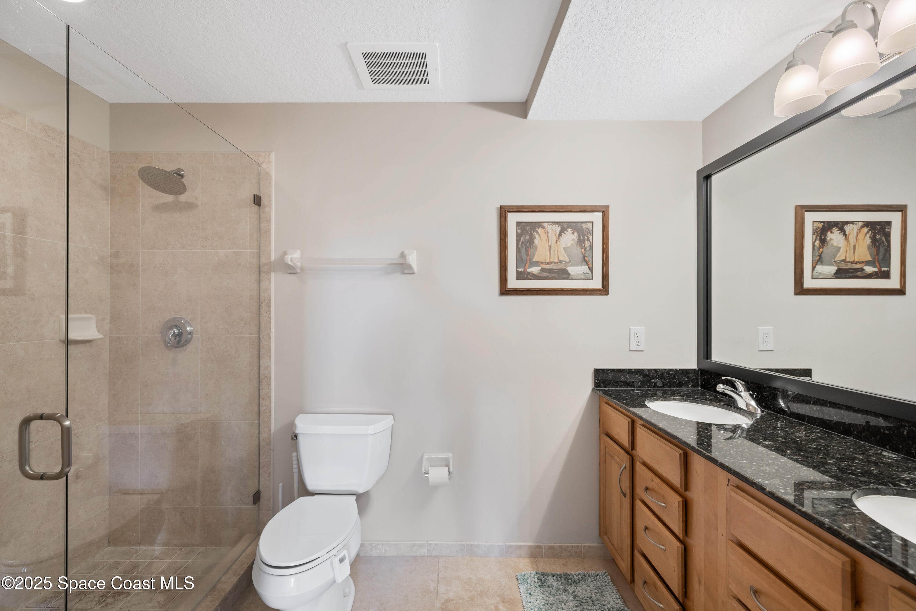1623 Indian River Drive, Unit 103 Sebastian, FL 32958 - Photo 33 of 36 a bathroom with a granite countertop toilet a sink and shower