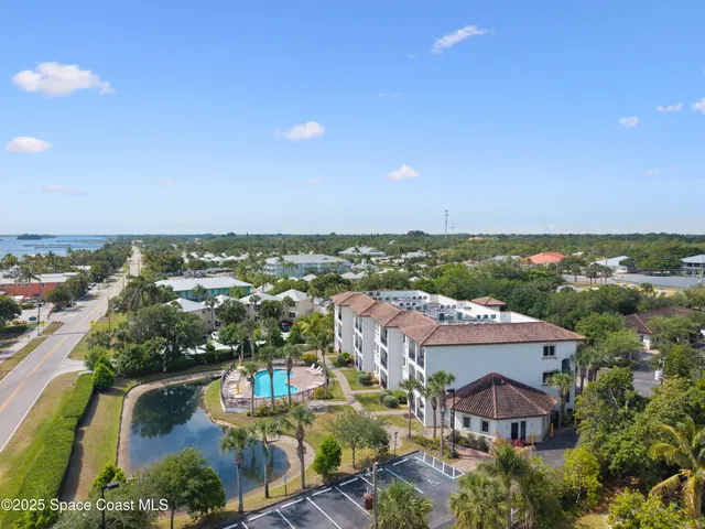 an aerial view of residential houses with outdoor space and swimming pool