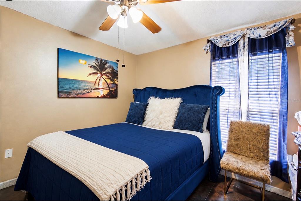 3005 West Chestnut Street Tampa, FL 33607 - Photo 17 of 27 a bedroom with a bed and a chandelier