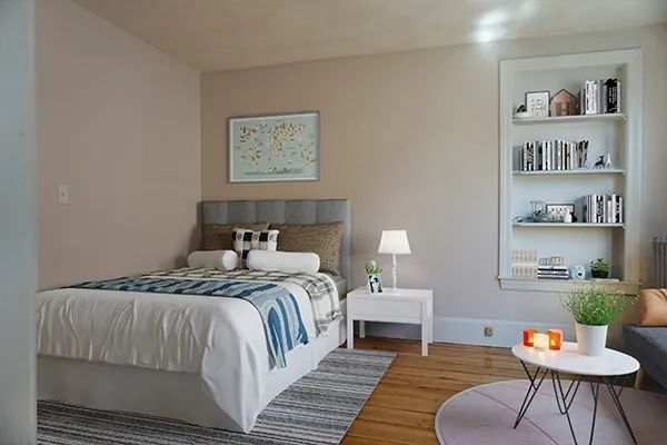 a bedroom with a bed and a couch