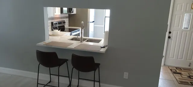 a dining room with table chairs and entryway