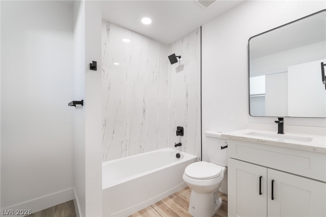 39 Lowery Street Henderson, NV 89015 - Photo 30 of 40 A pristine bathroom featuring a deep soaking tub and a sleek vanity with modern fixtures.