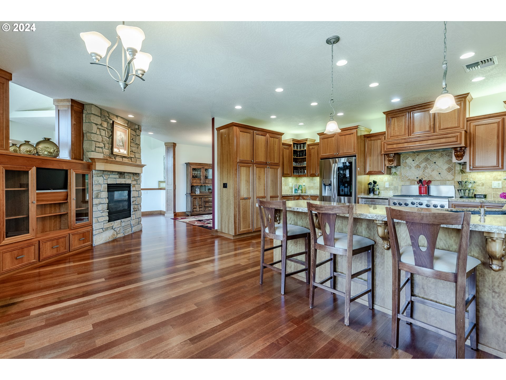 6188 Fernhill Loop Springfield, OR 97478 - Photo 12 of 40 a open kitchen view with stainless steel appliances granite countertop a dining table chairs and stove