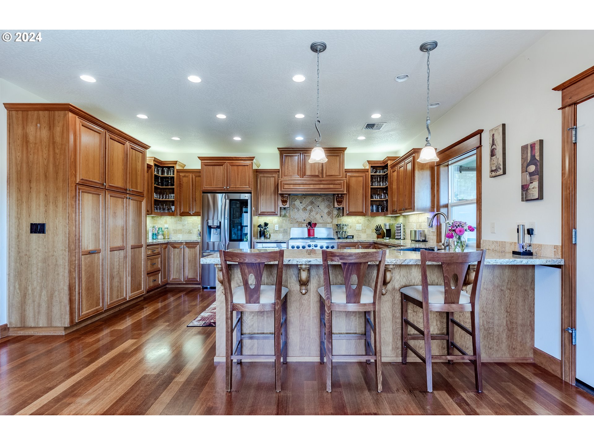 6188 Fernhill Loop Springfield, OR 97478 - Photo 13 of 40 a kitchen with stainless steel appliances kitchen island granite countertop a dining table chairs and a refrigerator