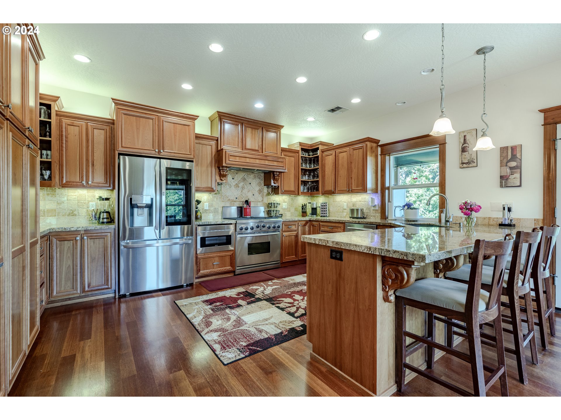 6188 Fernhill Loop Springfield, OR 97478 - Photo 14 of 40 a kitchen with stainless steel appliances granite countertop wooden cabinets a stove top oven a sink and dishwasher
