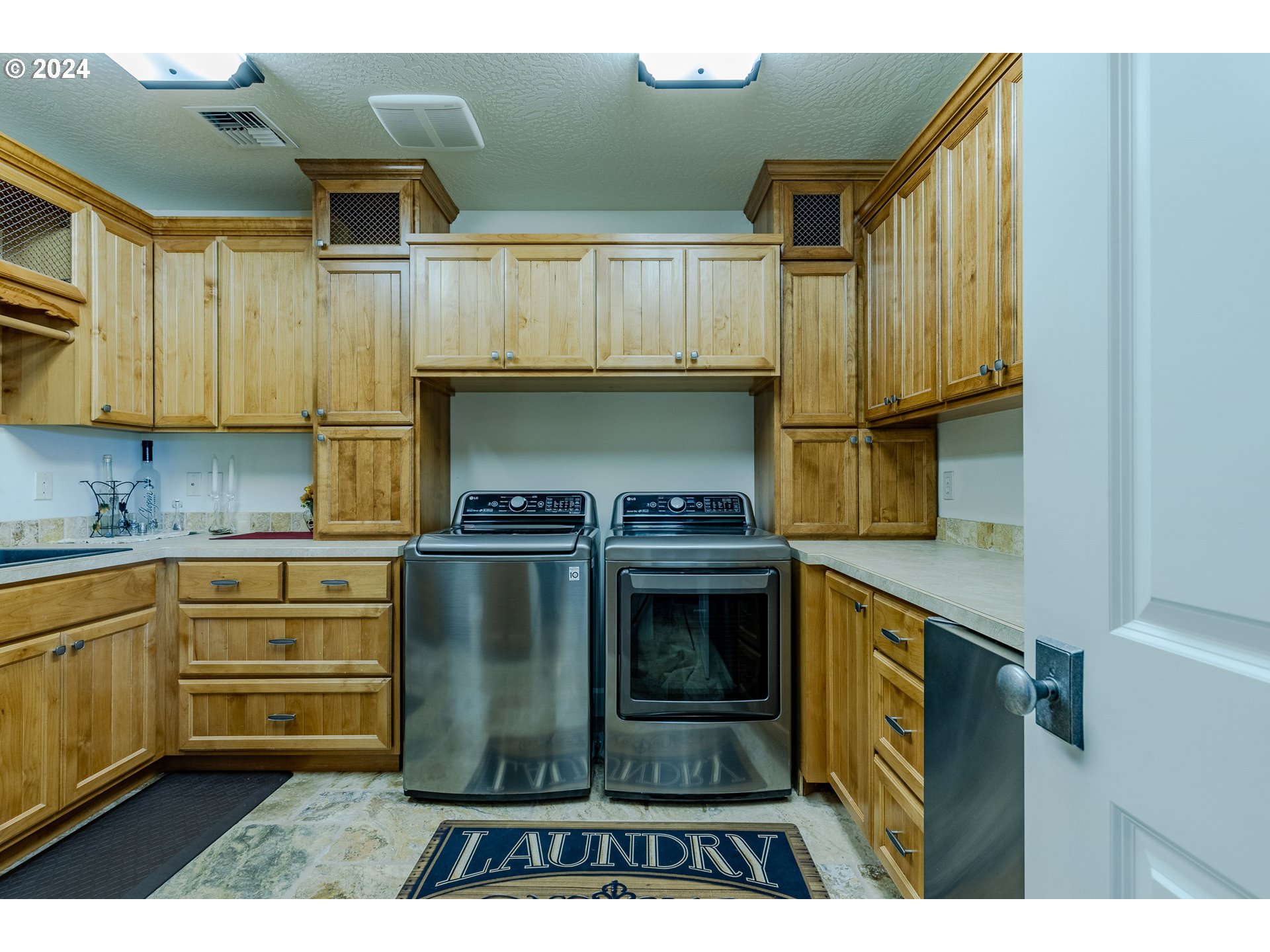 6188 Fernhill Loop Springfield, OR 97478 - Photo 22 of 40 a kitchen with kitchen island a sink stainless steel appliances and cabinets