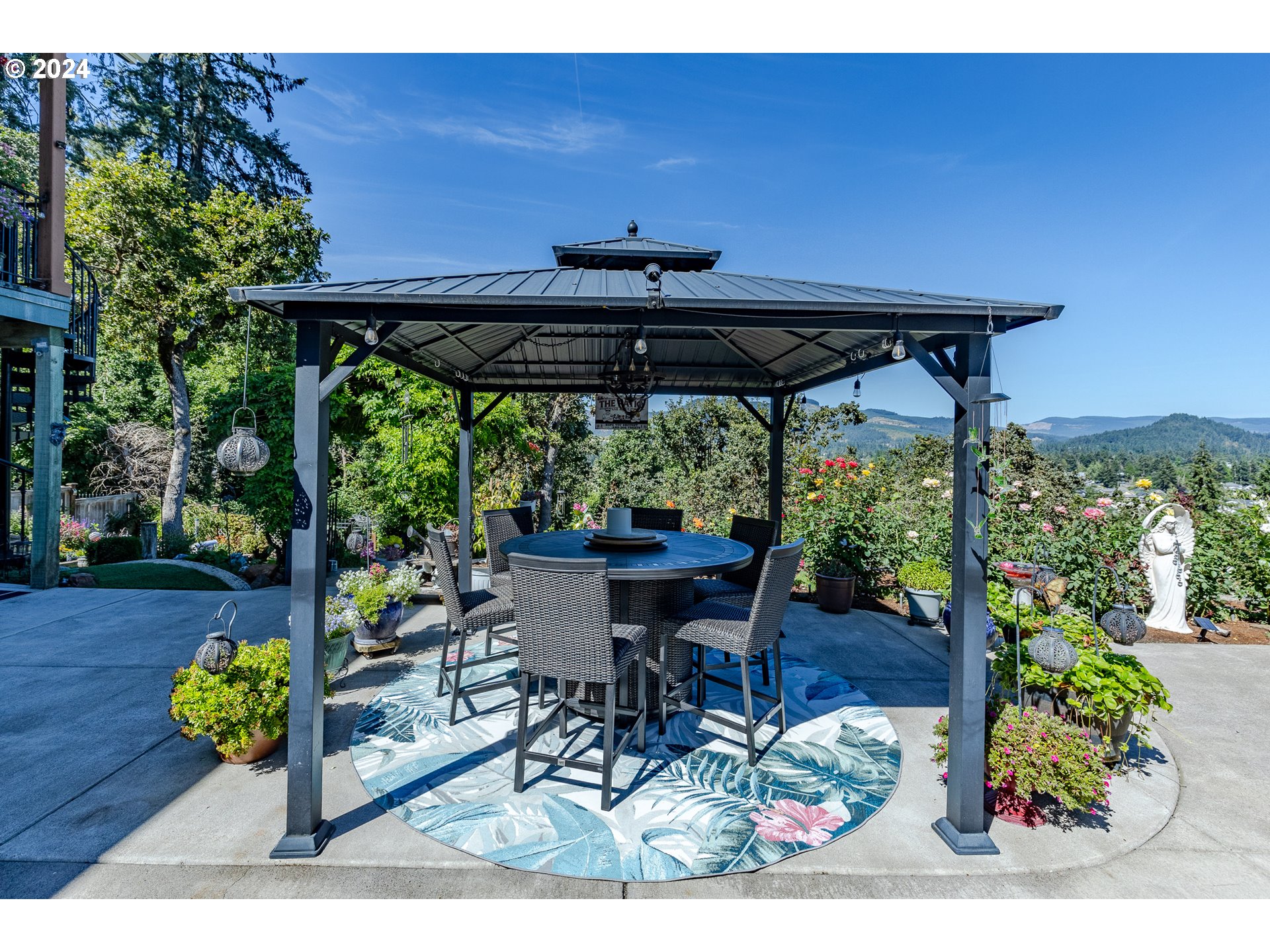 6188 Fernhill Loop Springfield, OR 97478 - Photo 26 of 40 a view of a patio with table and chairs potted plants with wooden floor