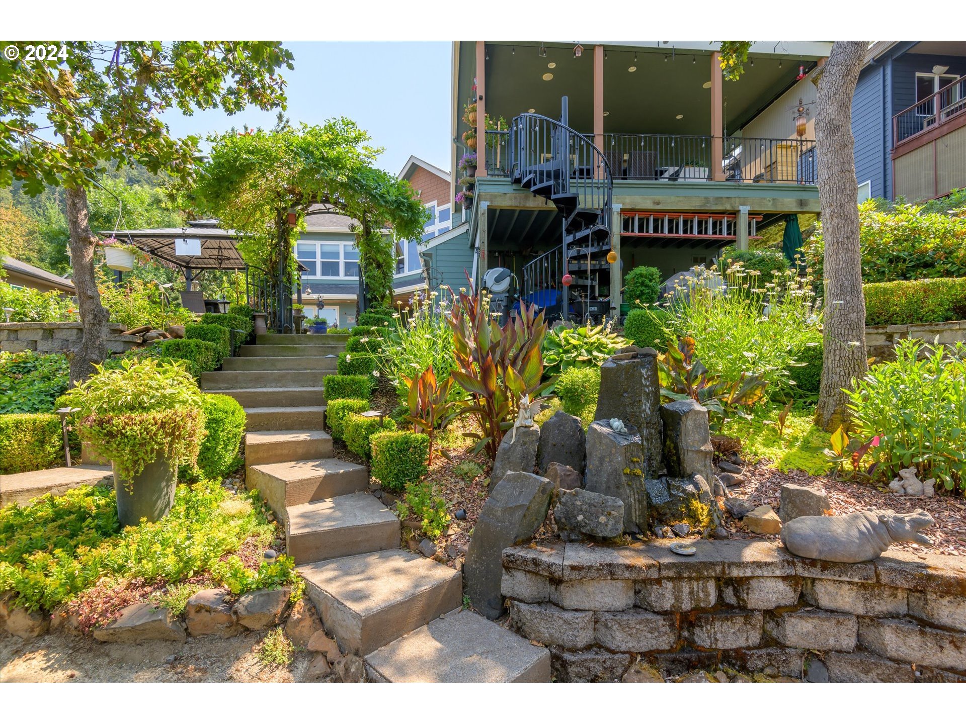 6188 Fernhill Loop Springfield, OR 97478 - Photo 32 of 40 a front view of a house with a yard and garden