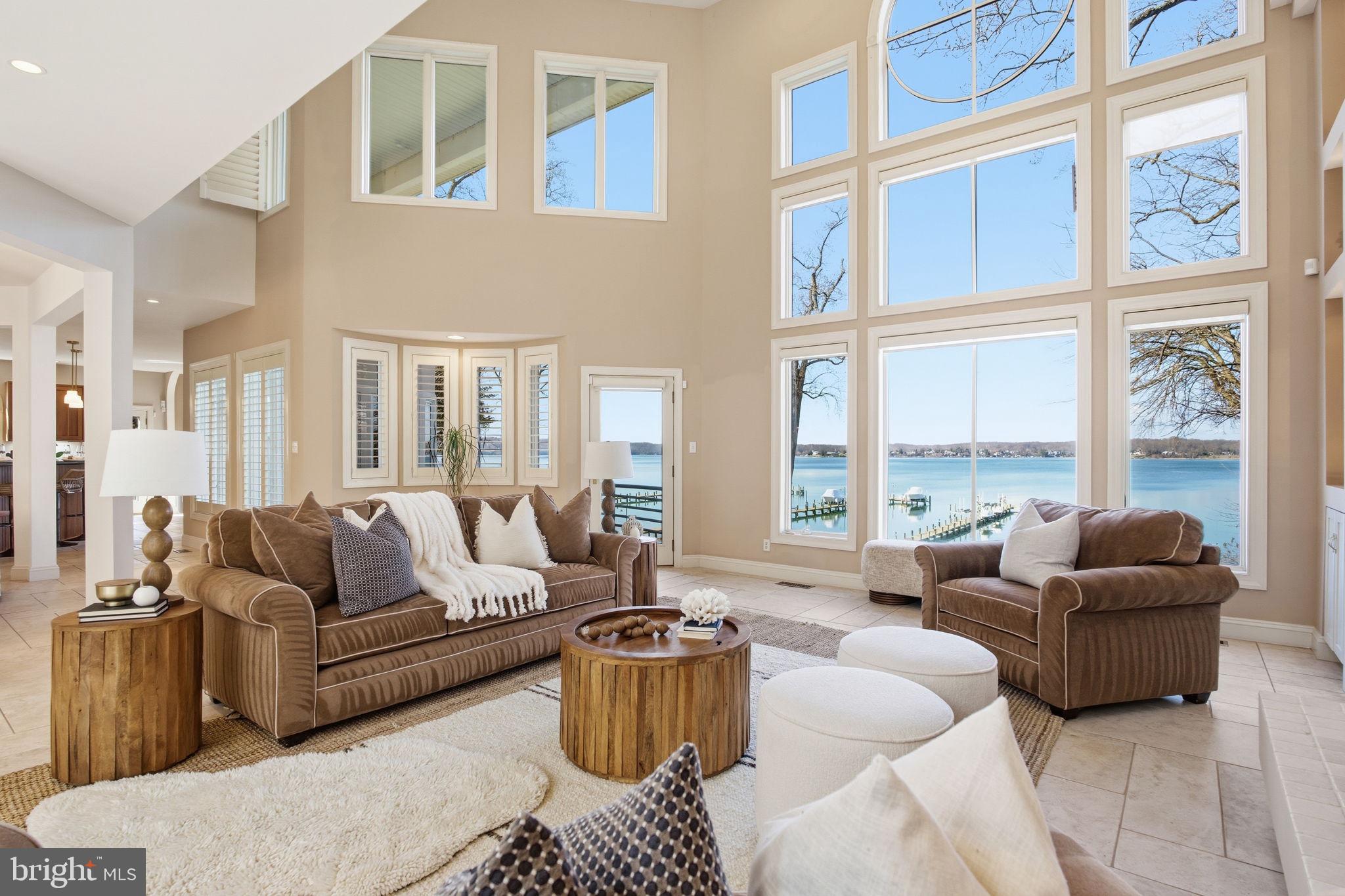a living room with furniture and floor to ceiling windows