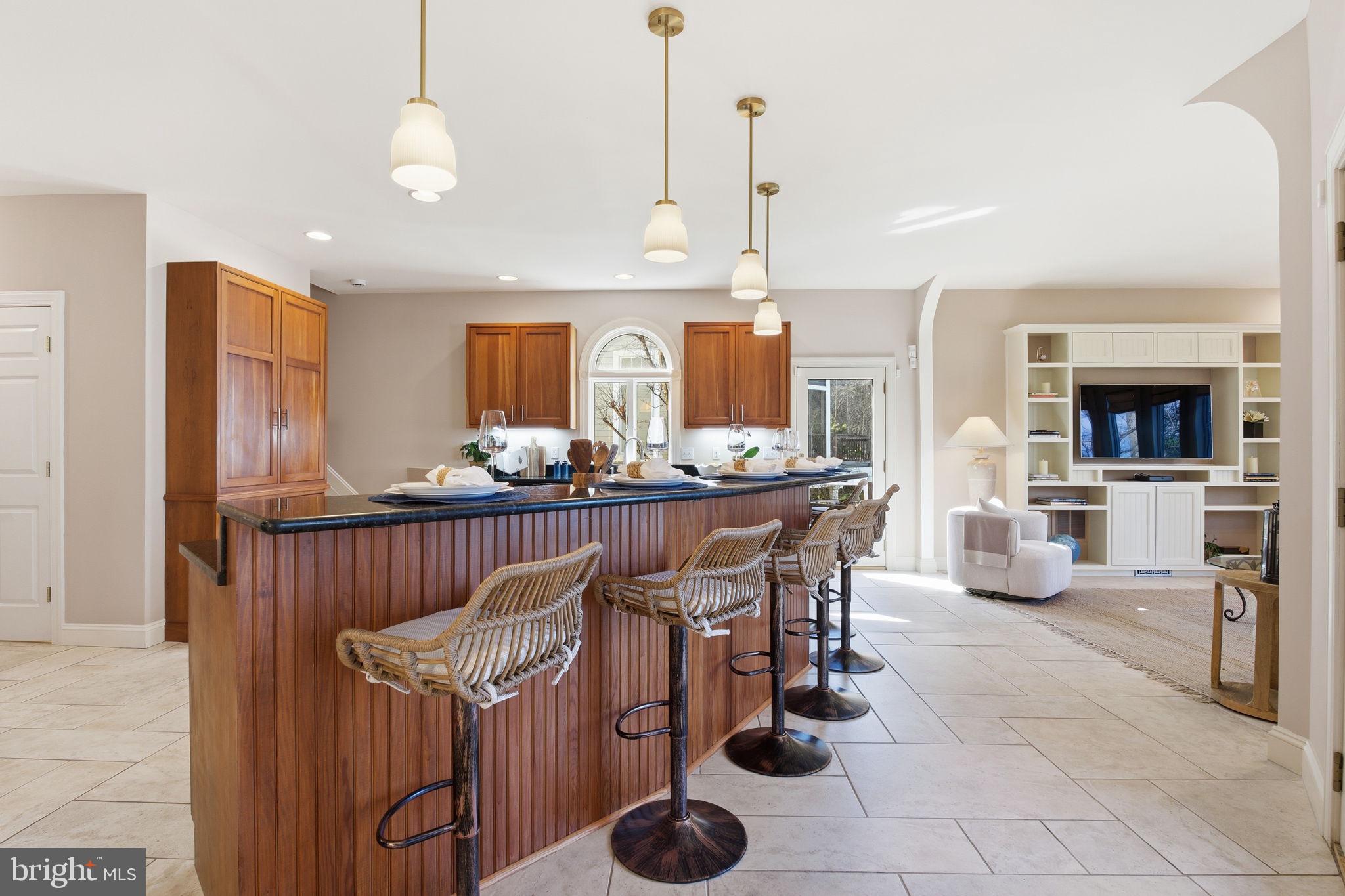 922 Old County Road Severna Park, MD 21146 - Photo 17 of 61 a kitchen with granite countertop a table and chairs in it