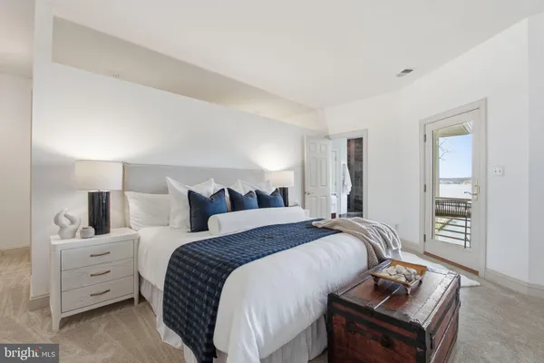 a bedroom with a large bed and a dresser