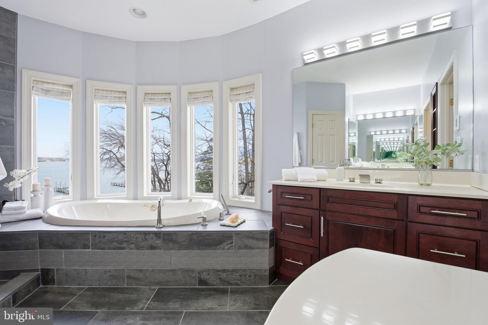 922 Old County Road Severna Park, MD 21146 - Photo 26 of 61 a bathroom with a bathtub double sink and large mirror
