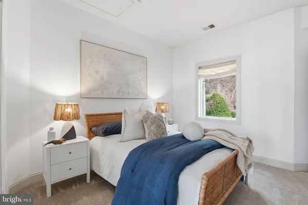 a spacious bedroom with a bed and a window