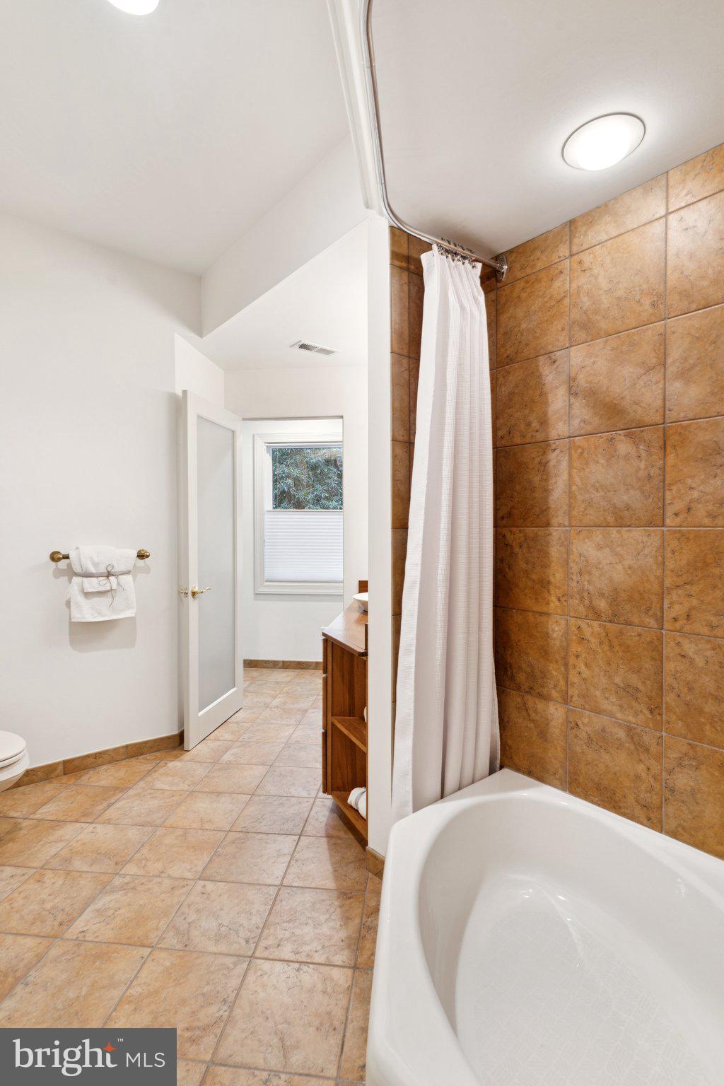 922 Old County Road Severna Park, MD 21146 - Photo 34 of 61 a bathroom with a bathtub and a shower