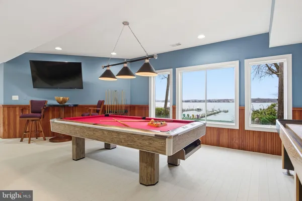 a room with table tennis air hockey table and arcade game machine