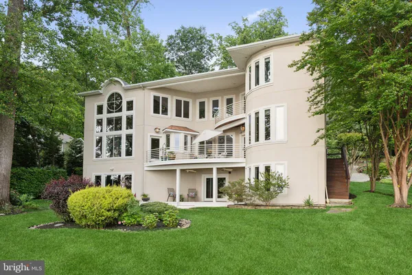 a front view of a house with a garden and plants