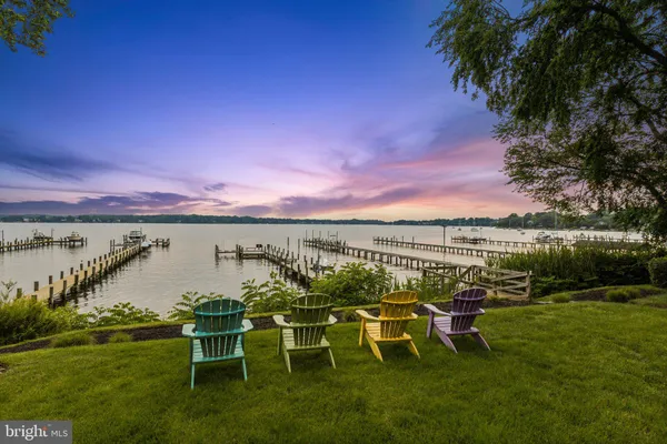 a view of a lake with a table and chairs