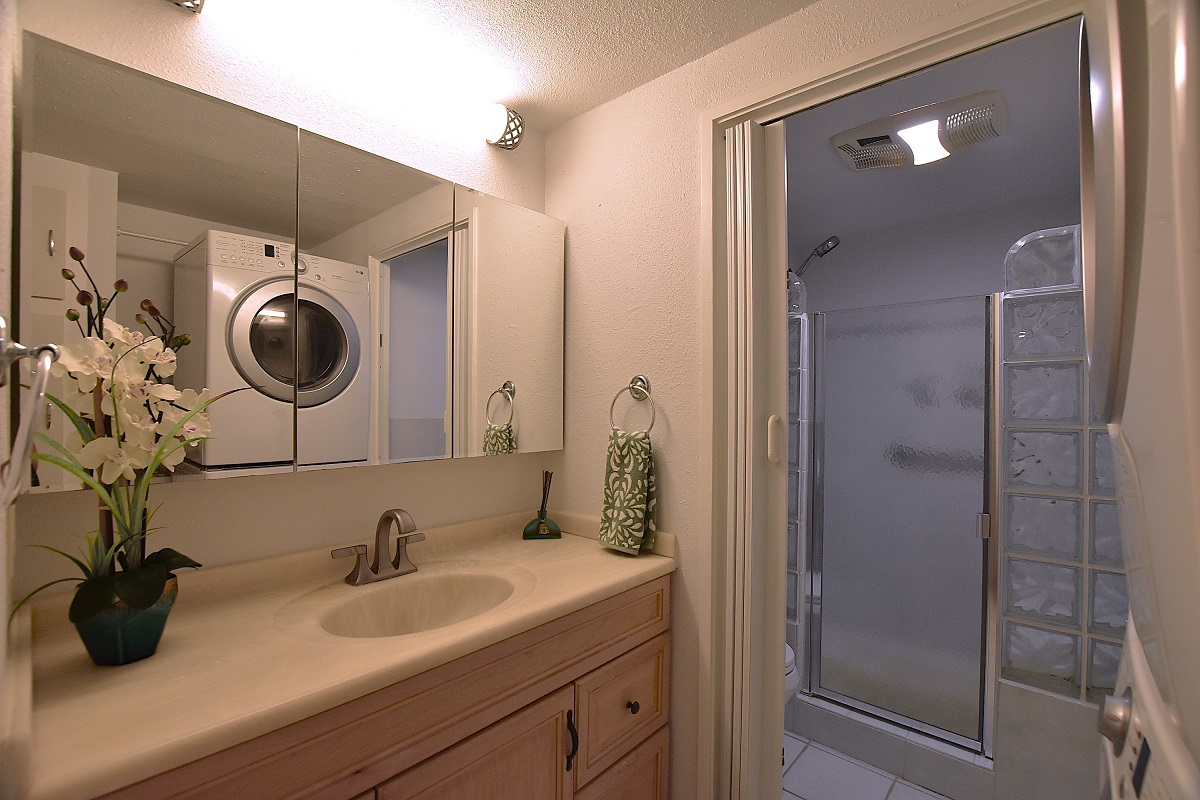 68-3840 Lua Kula Street, Unit D203 Waikoloa, HI 96738 - Photo 13 of 30 a bathroom with a sink and a mirror