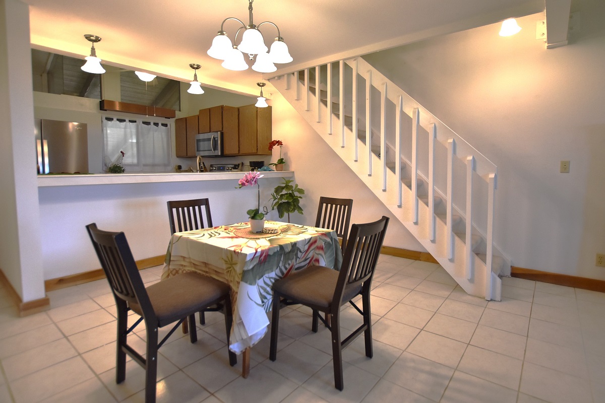 68-3840 Lua Kula Street, Unit D203 Waikoloa, HI 96738 - Photo 5 of 30 a view of a dining room with furniture and a chandelier