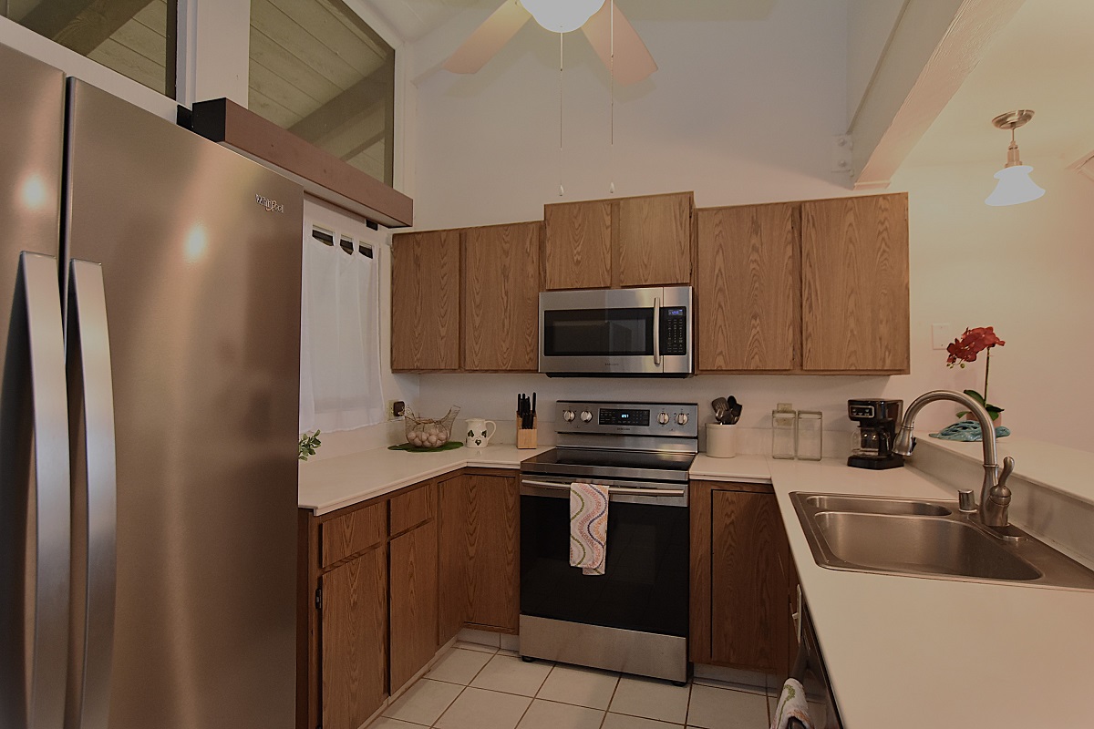 68-3840 Lua Kula Street, Unit D203 Waikoloa, HI 96738 - Photo 6 of 30 a kitchen with stainless steel appliances a sink a stove a microwave a refrigerator a sink and cabinets