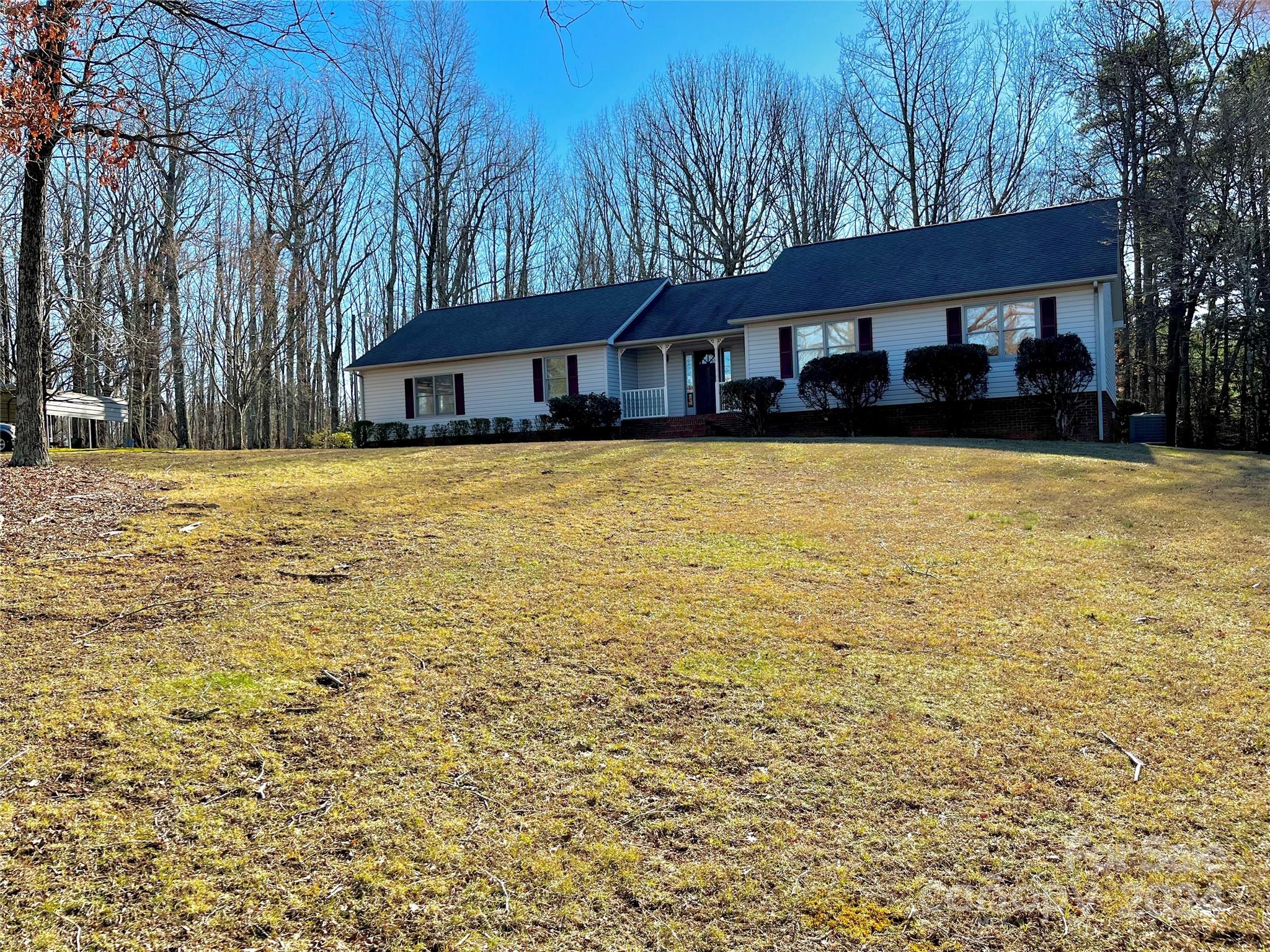 2239 Tryon Courthouse Road Bessemer City, NC 28016 - Photo 1 of 26 a front view of a house with yard and trees