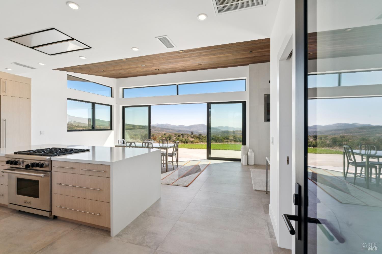 3400 Atlas Peak Road Napa, CA 94558 - Photo 10 of 34 a open kitchen with stainless steel appliances granite countertop a stove and a view of living room