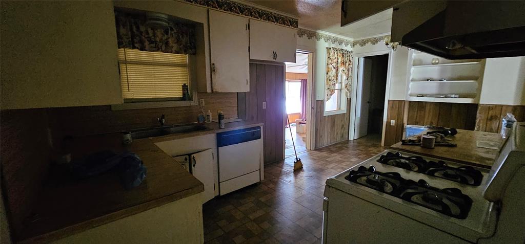403 North Park Drive Springhill, LA 71075 - Photo 19 of 31 a kitchen with a stove and a wooden cabinets