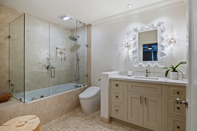 a spacious bathroom with a granite countertop sink toilet and shower