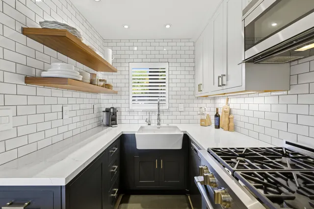 a kitchen that has a sink and a stove
