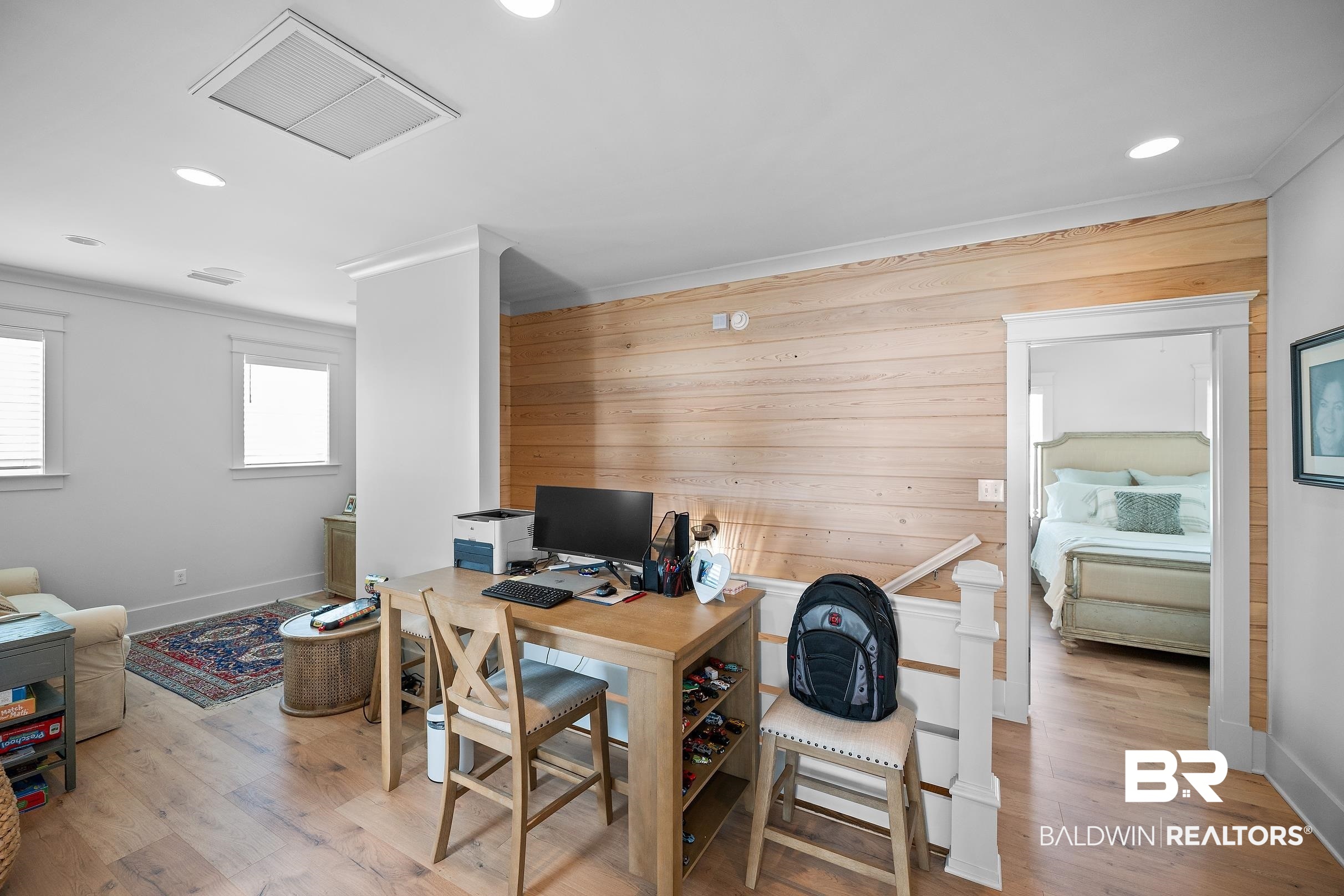 33186 Marlin Key Drive Orange Beach, AL 36561 - Photo 64 of 87 Home office with recessed lighting, light wood finished floors, wooden walls, and crown molding