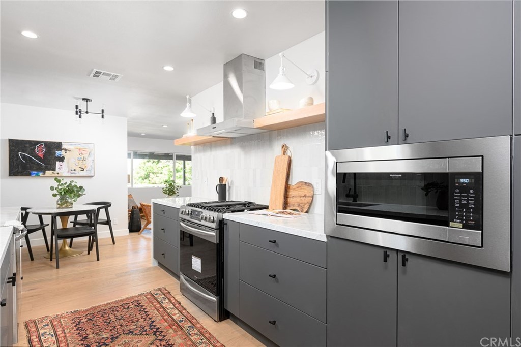 5418 Sanchez Drive Los Angeles, CA 90008 - Photo 14 of 28 a kitchen with stainless steel appliances granite countertop a stove a sink and a microwave
