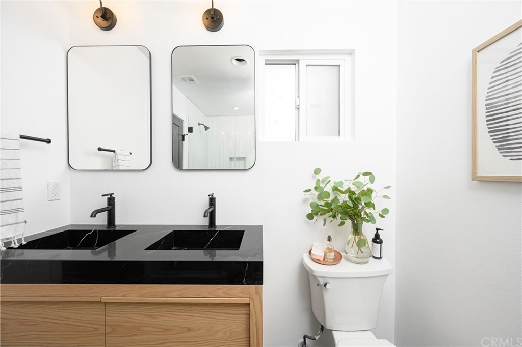 5418 Sanchez Drive Los Angeles, CA 90008 - Photo 17 of 28 a bathroom with a sink a mirror and a toilet