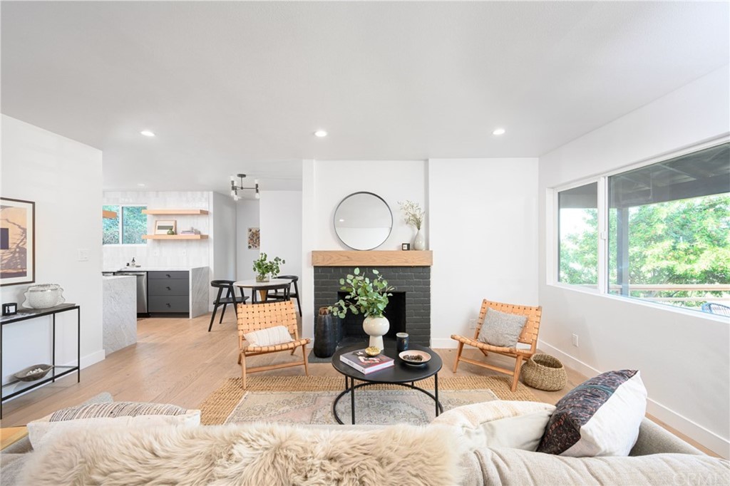 5418 Sanchez Drive Los Angeles, CA 90008 - Photo 6 of 28 a living room with furniture a large window and a fireplace