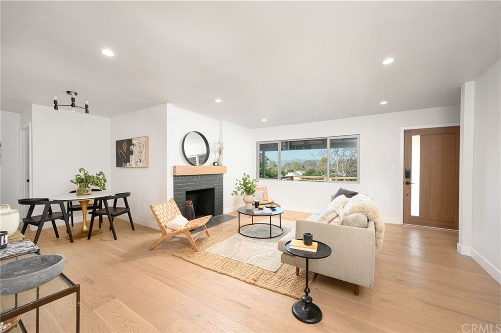 5418 Sanchez Drive Los Angeles, CA 90008 - Photo 7 of 28 a living room with furniture a fireplace and a table