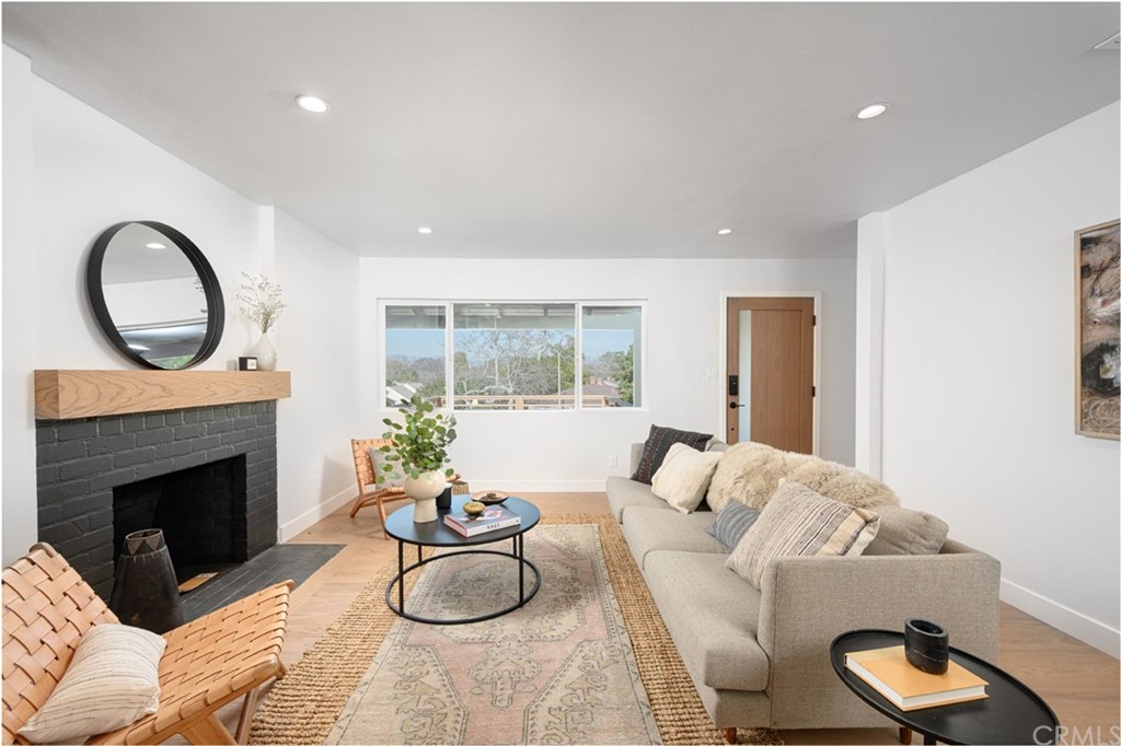 5418 Sanchez Drive Los Angeles, CA 90008 - Photo 8 of 28 a living room with furniture a fireplace and a floor to ceiling window
